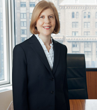 Closeup headshot of a woman in black blazer